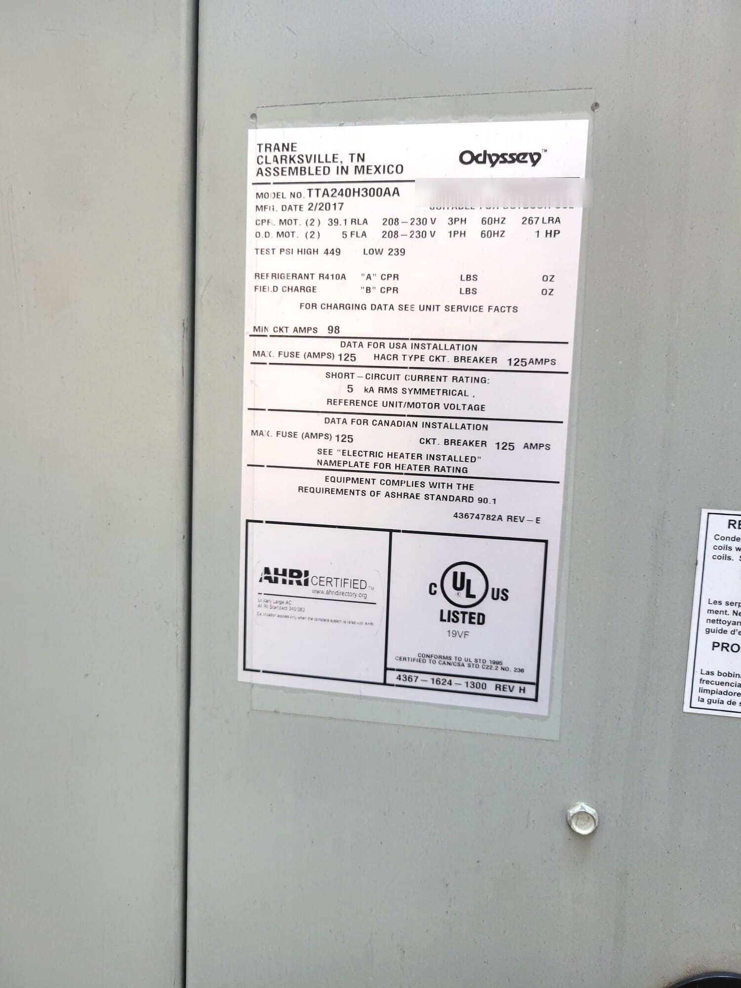 TRANE Odyssey rooftop unit rating plate showing model number and electrical data, serial masked