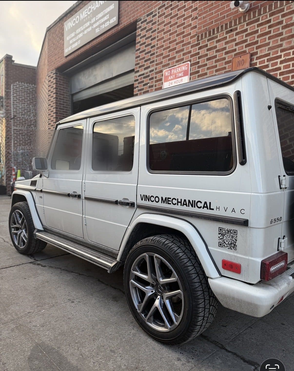 White Mercedes G-Wagon in Vinco Mechanical livery parked at the 993 Grand Street shop in Brooklyn at golden hour, shop signage above