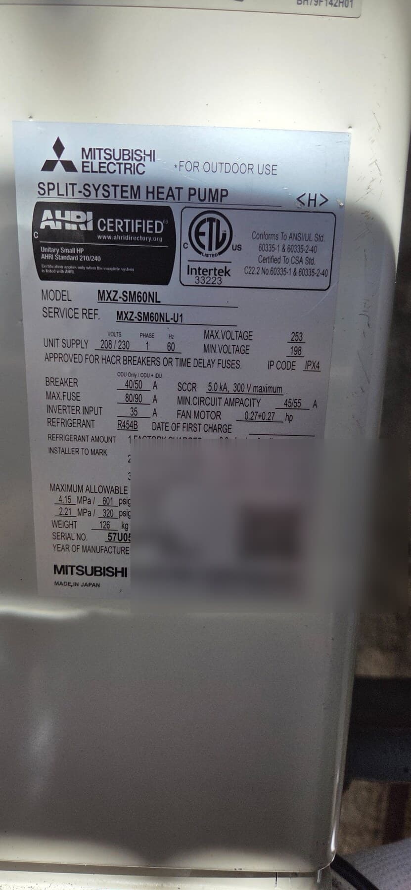 Mitsubishi MXZ-SM60NL dataplate showing R-454B refrigerant, serial masked